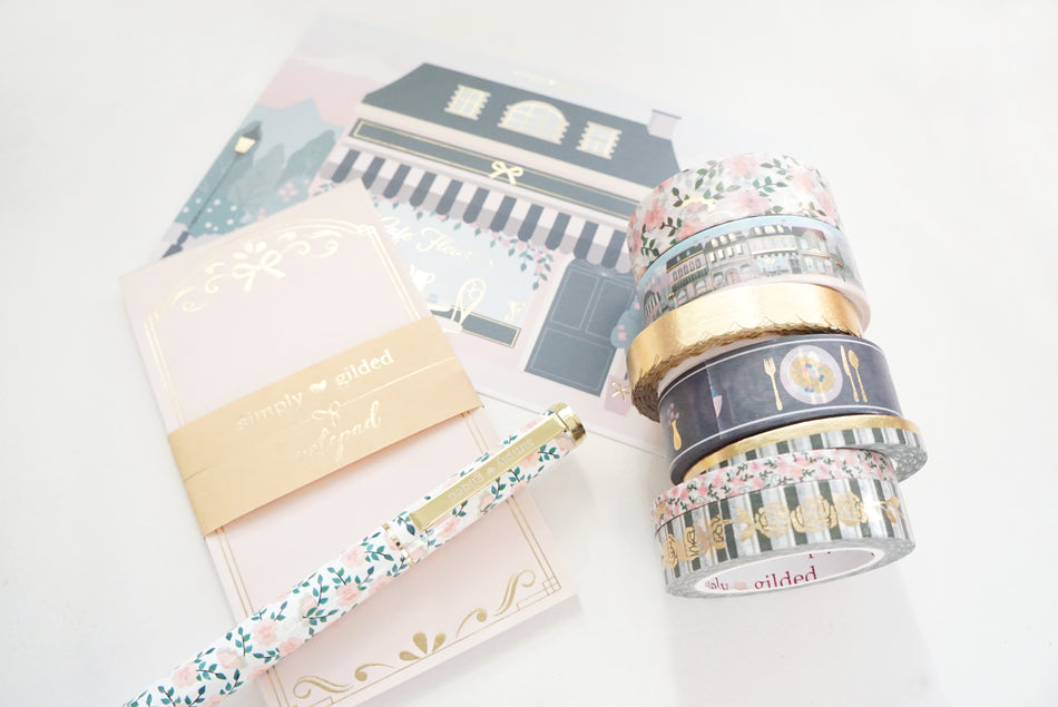 Styled desk scene with washi tape, stickers and journaling supplies